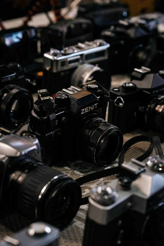 a group of electronic camera with a camera body in the foreground