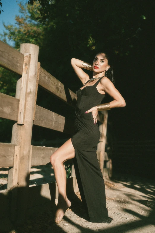 a woman is posing in a  black dress