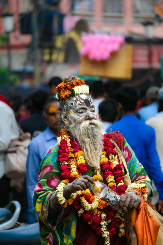 a man with face paint stands in front of a crowd