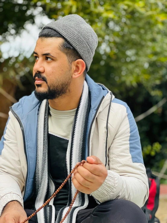 a man sitting on a step with his hand on a string