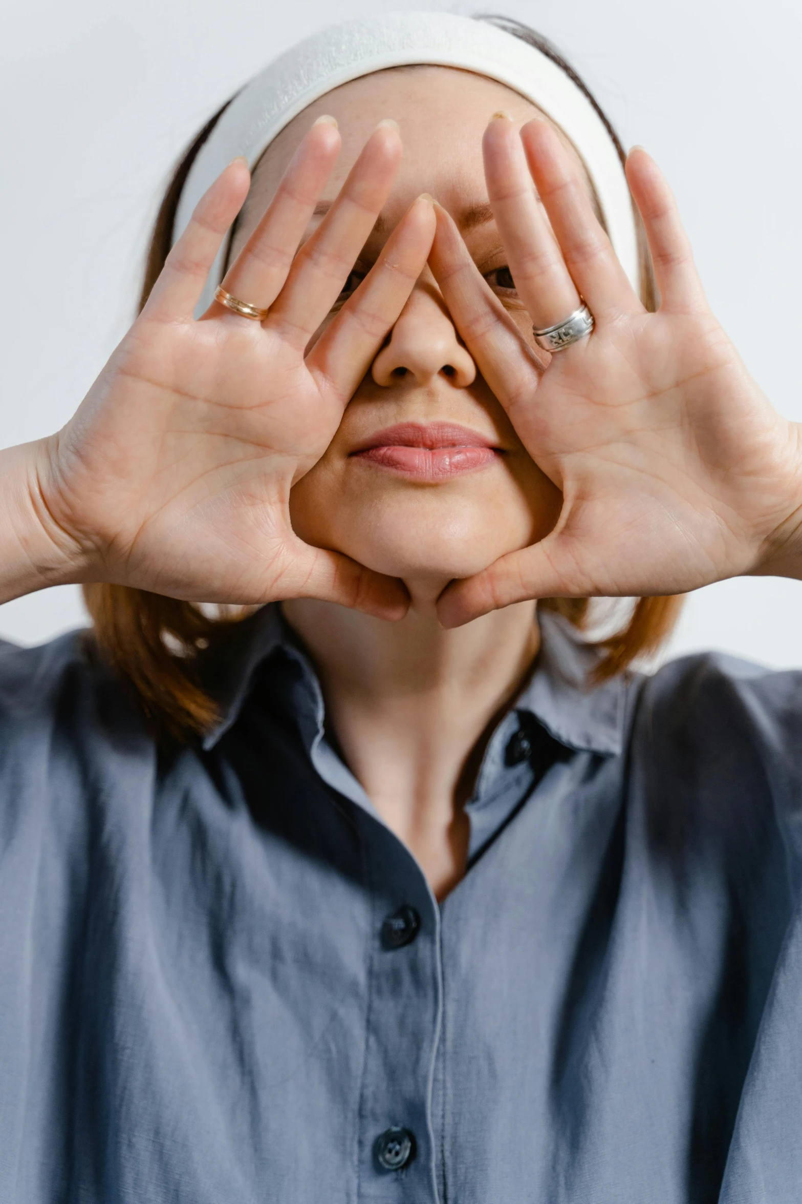 a person standing with their hands on their head