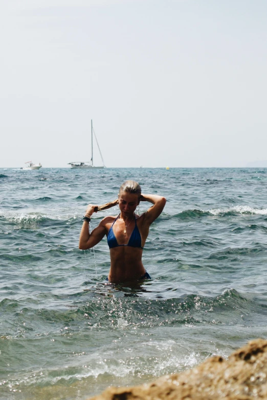 a woman is bathing in the ocean waters