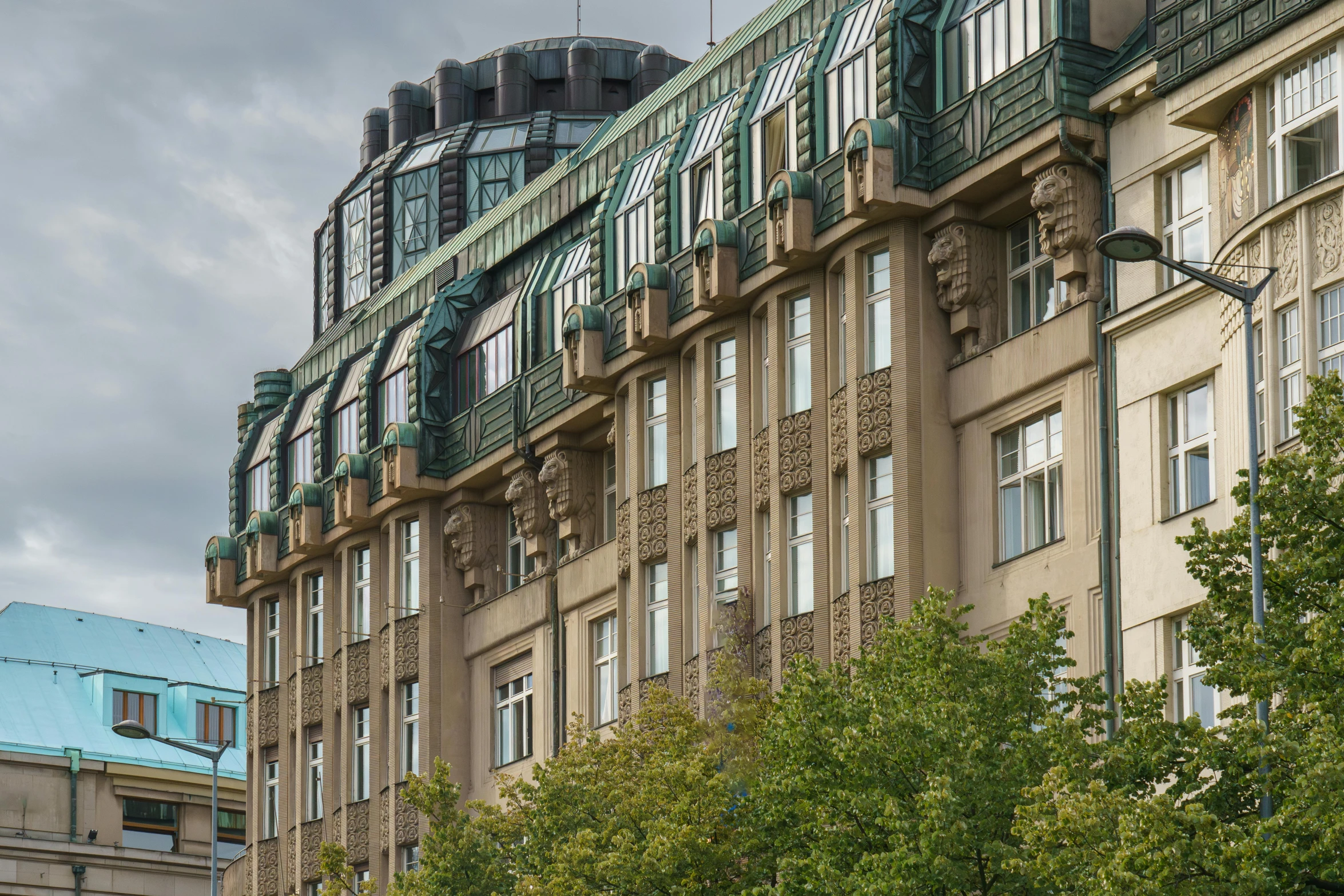 two large buildings sitting behind a row of trees