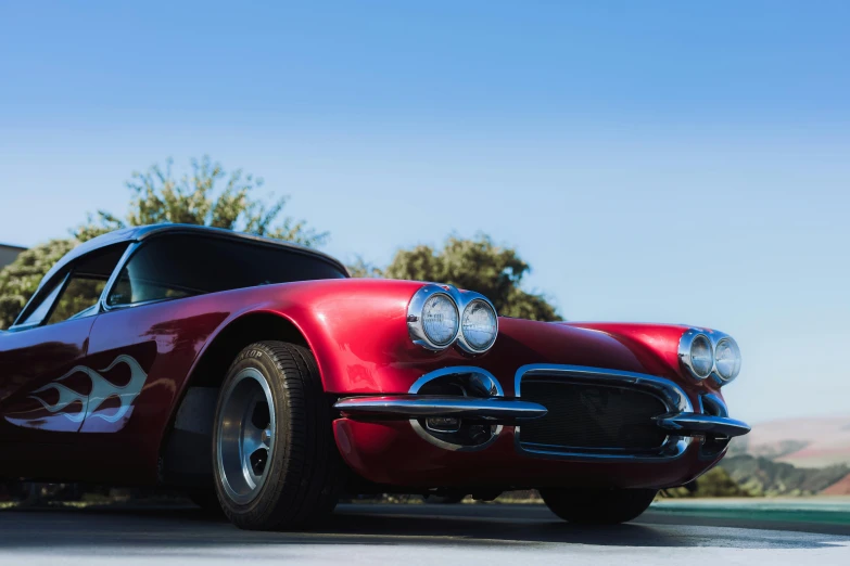 a red vintage car that is parked outside