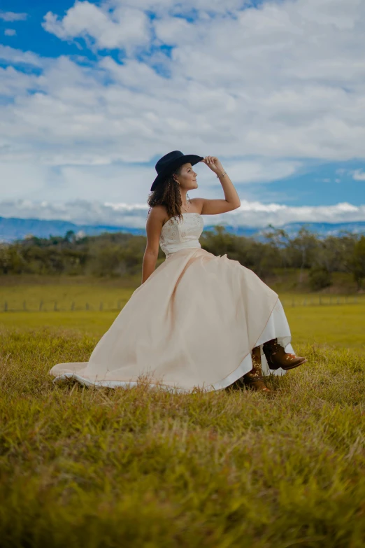 a young woman sitting on top of a lush green field