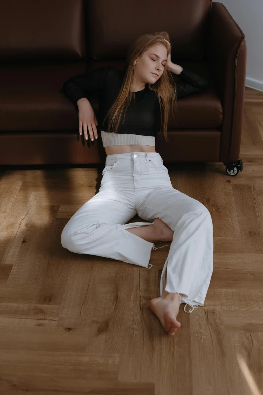 a woman sits on a couch with her legs crossed