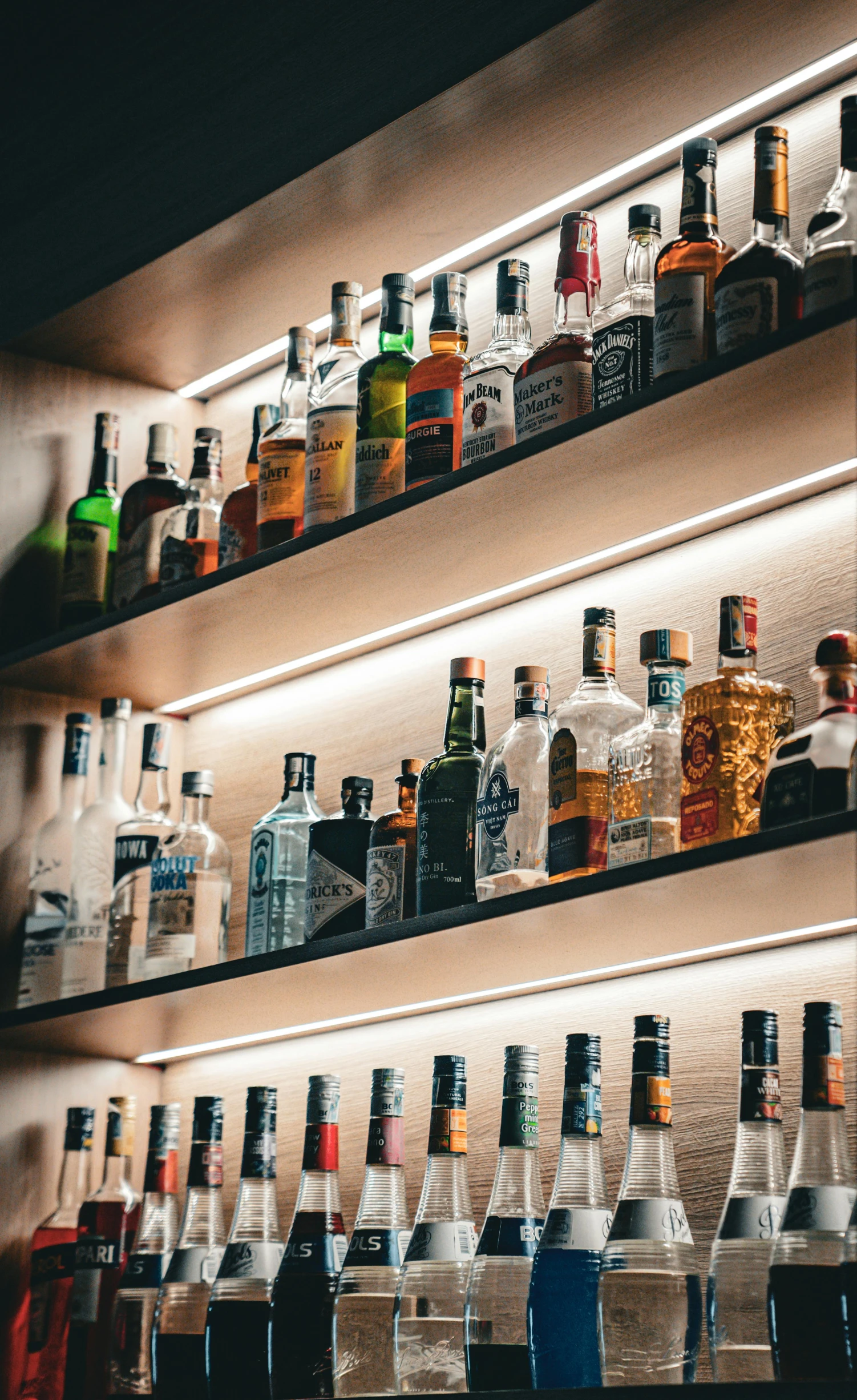 a bar stocked with many different colored bottles