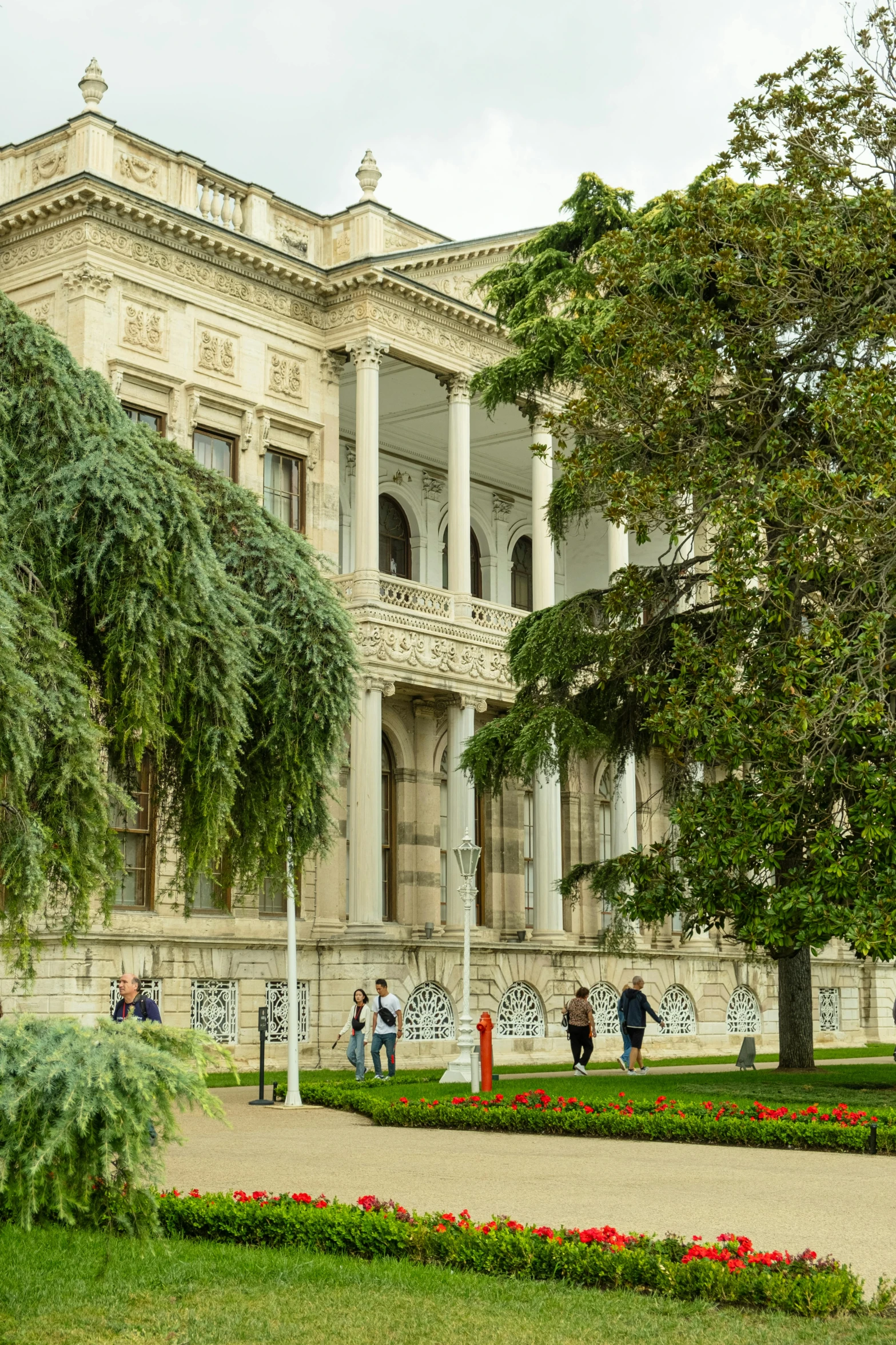 a large white and tan building with a lot of pillars on it