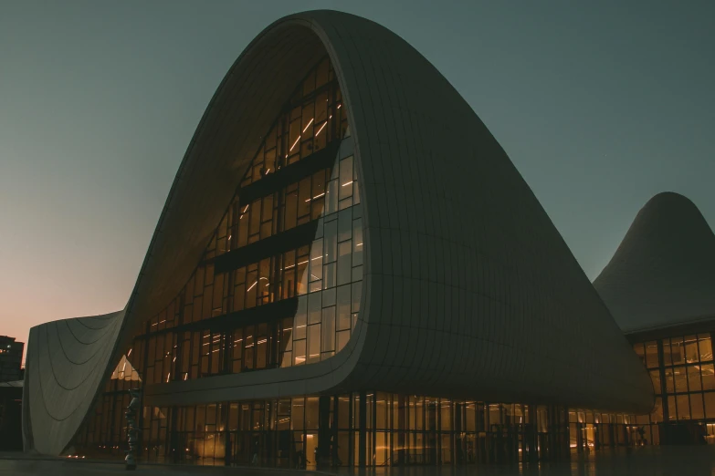 a building made of glass and is lit up at night