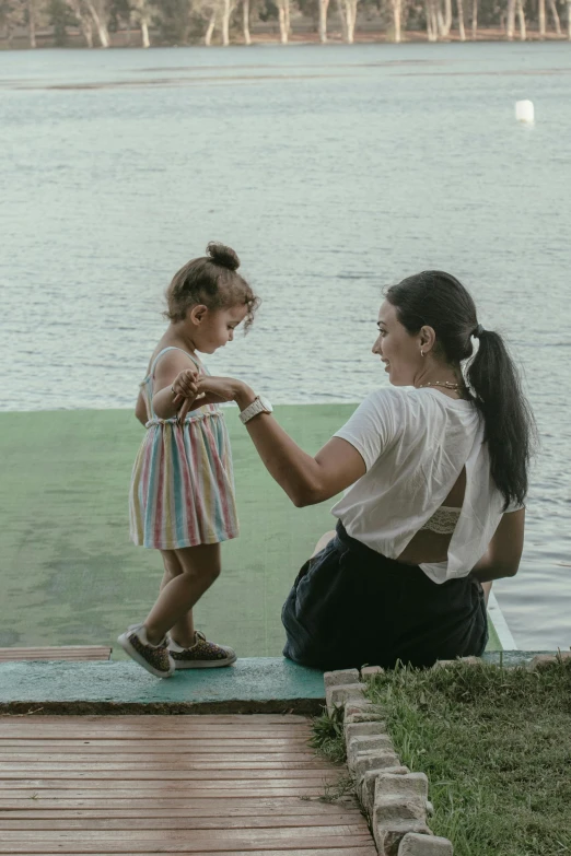 a little girl and her mother getting ready to fly a kite