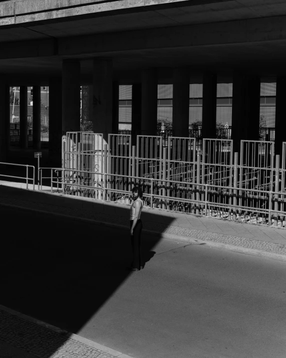 black and white po of person standing by building