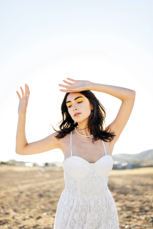 an asian woman is standing in a field