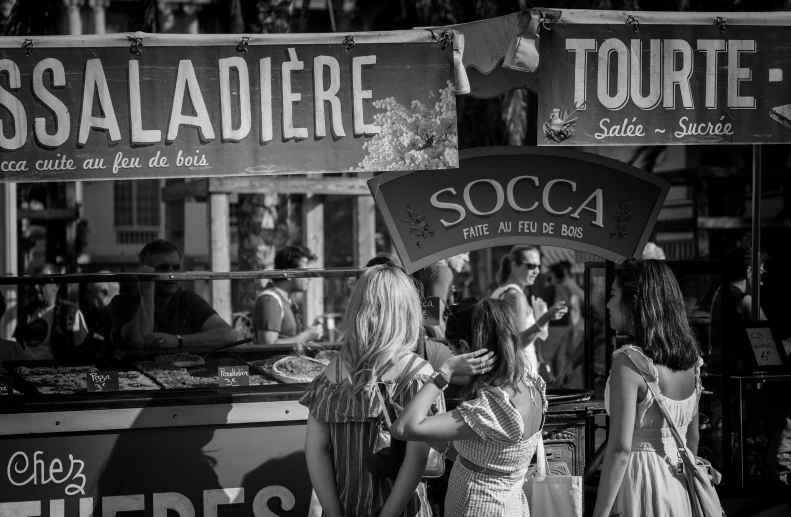 a group of ladies standing in front of a restaurant