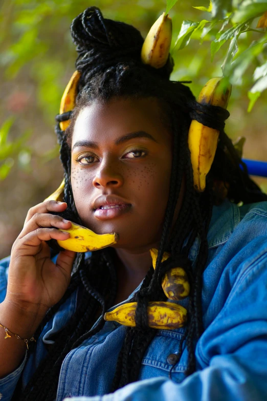 the person with bananas tied to their hair on their head is using a telephone