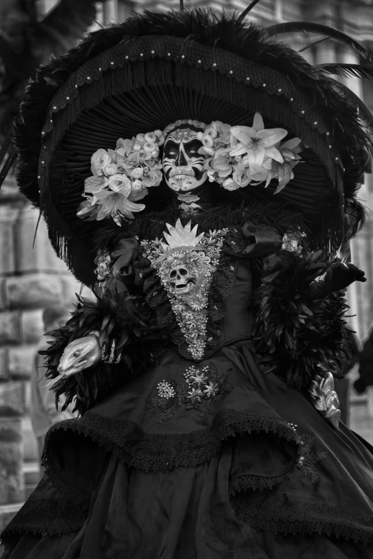 a woman dressed up in a dress and hat with floral decorations