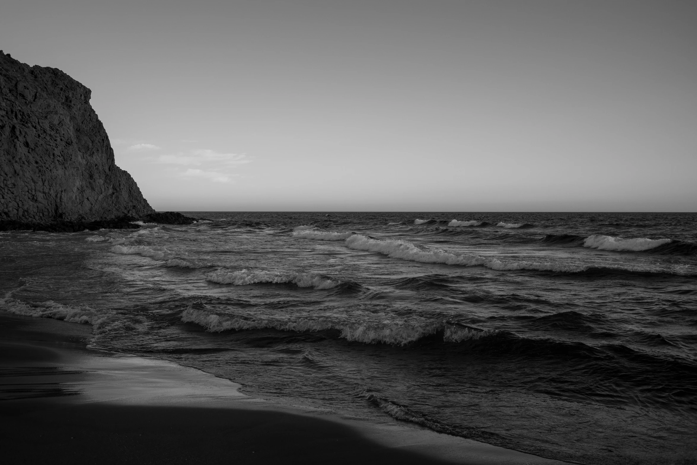 two large rocks in the distance over the ocean