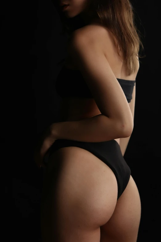 a woman in a black underwear posing for a camera