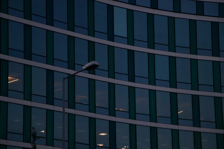 a tall building with lots of windows at night