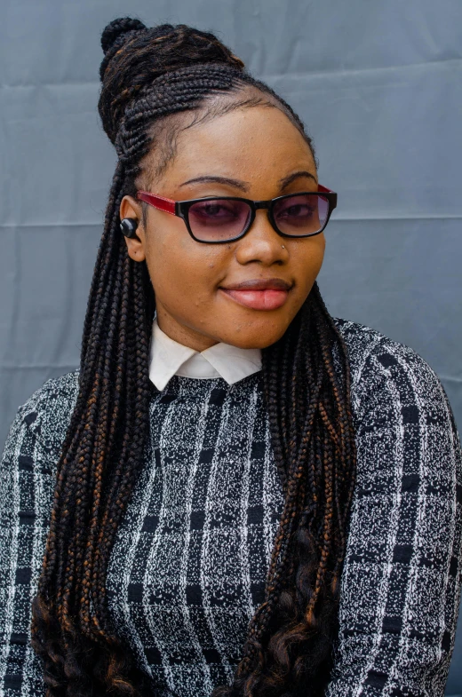 a woman with glasses that is wearing long dreadlocks