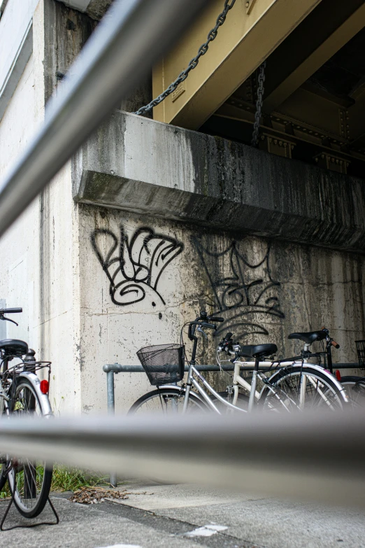 a picture of some bikes and graffiti under an overpass