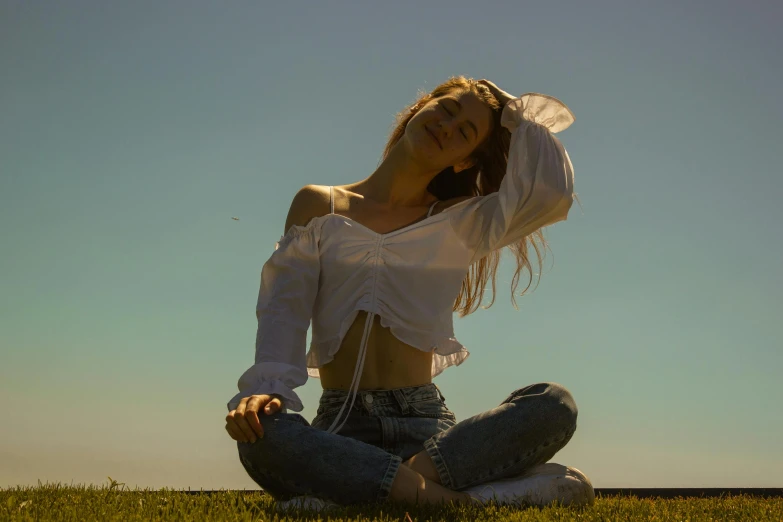 woman sitting cross legged in front of sun