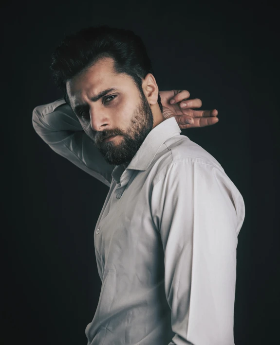 an image of man with beard in white shirt