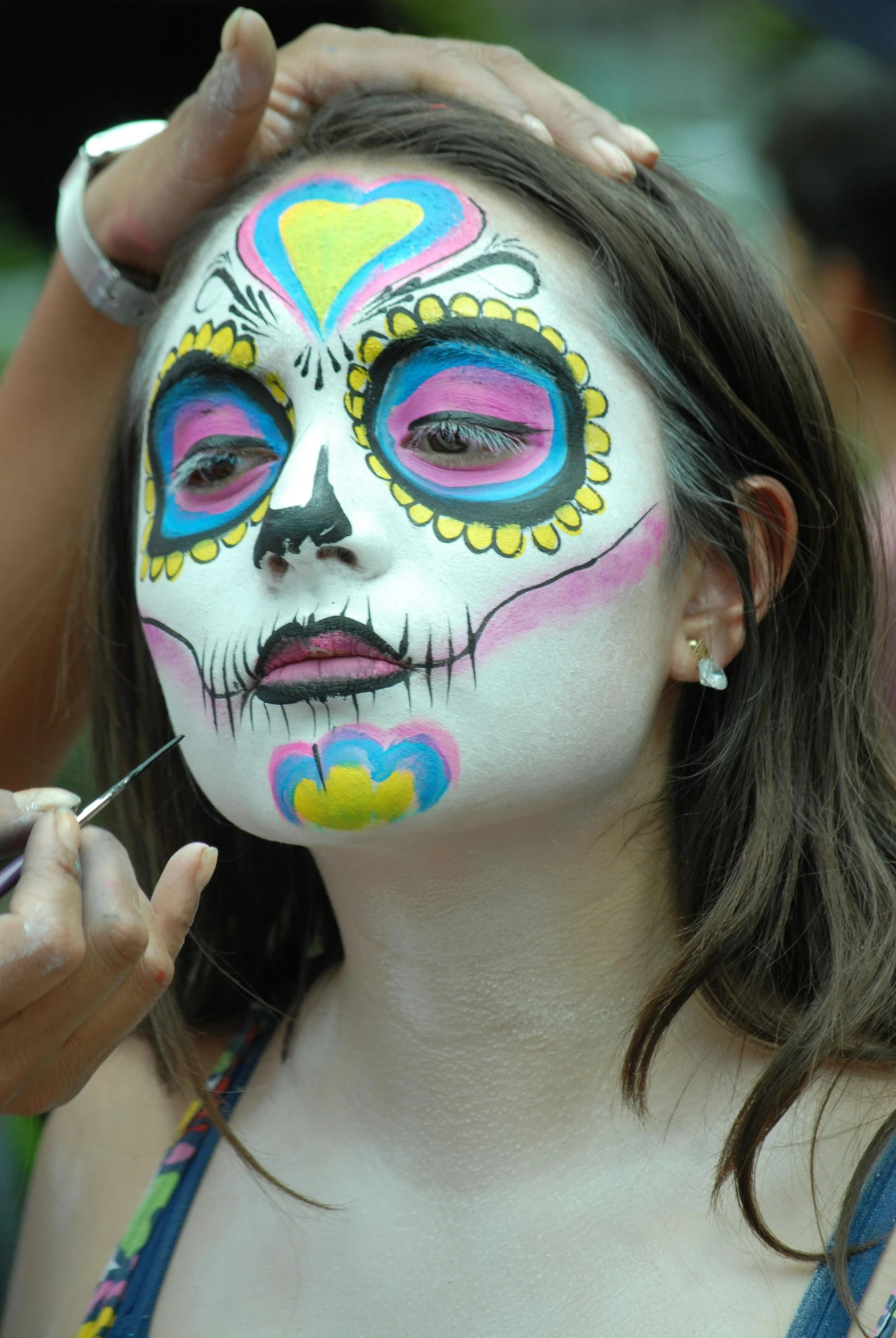 a woman with her face painted as a skeleton