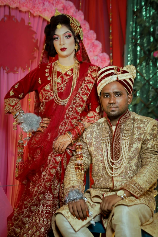 two people dressed in traditional indian clothing