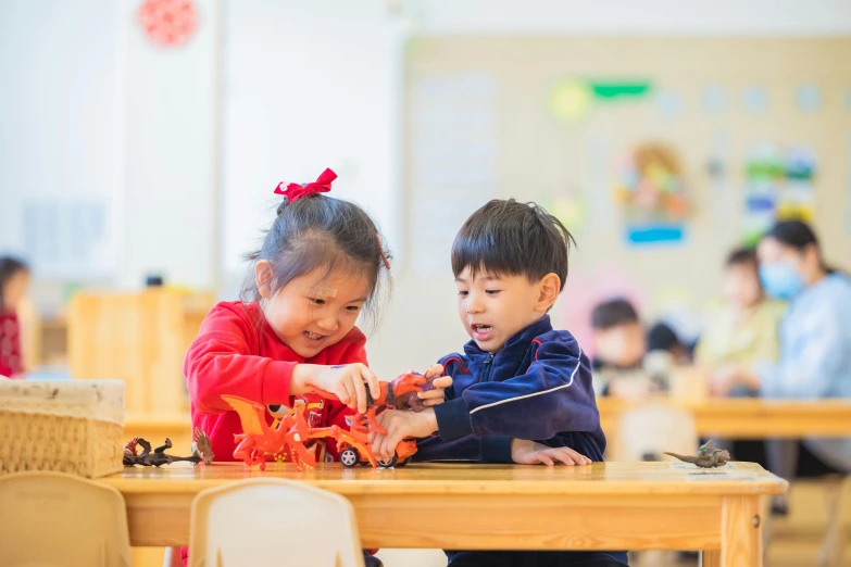 the two children are playing with their plastic vehicles