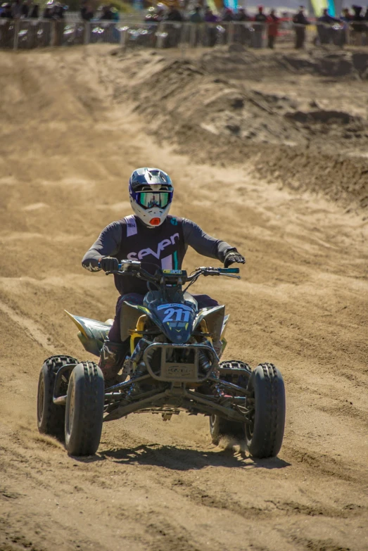 the racer is riding a four wheeler and turning a corner