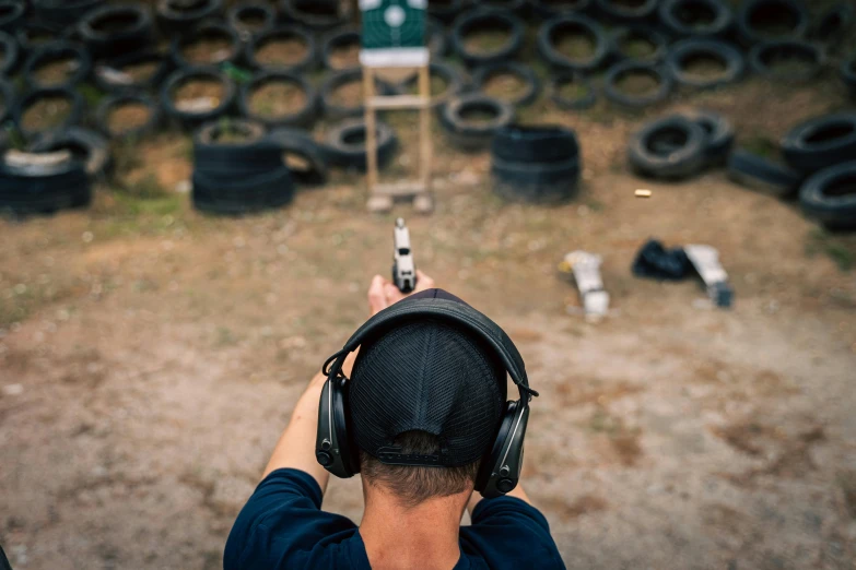 a man with headphones and a hat is shooting