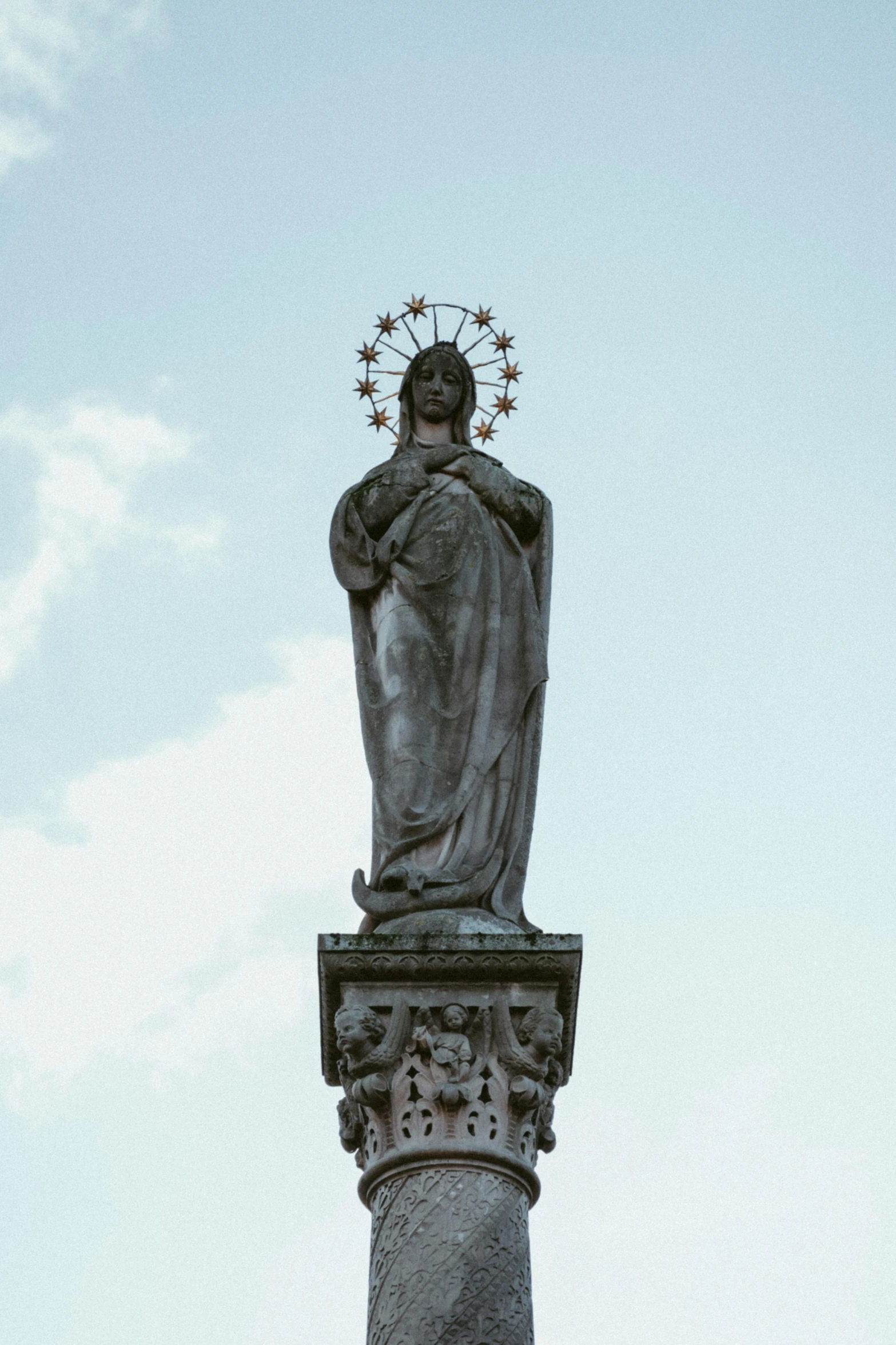 a very tall statue sitting under a blue sky