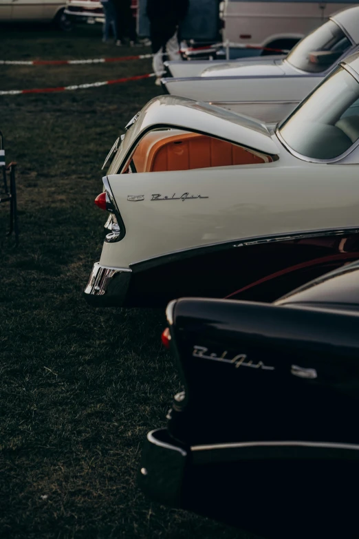 row of cars in parking lot at old time event