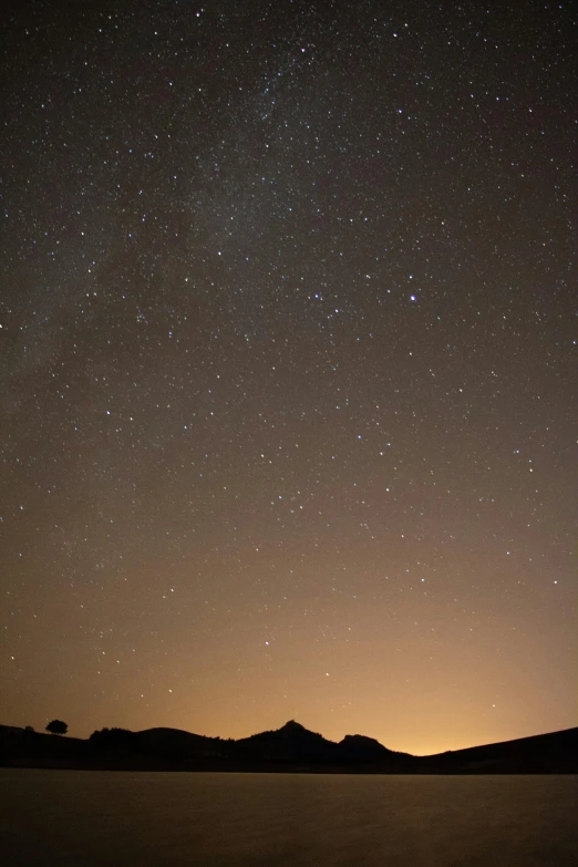 the view from a distance at night, the stars are above