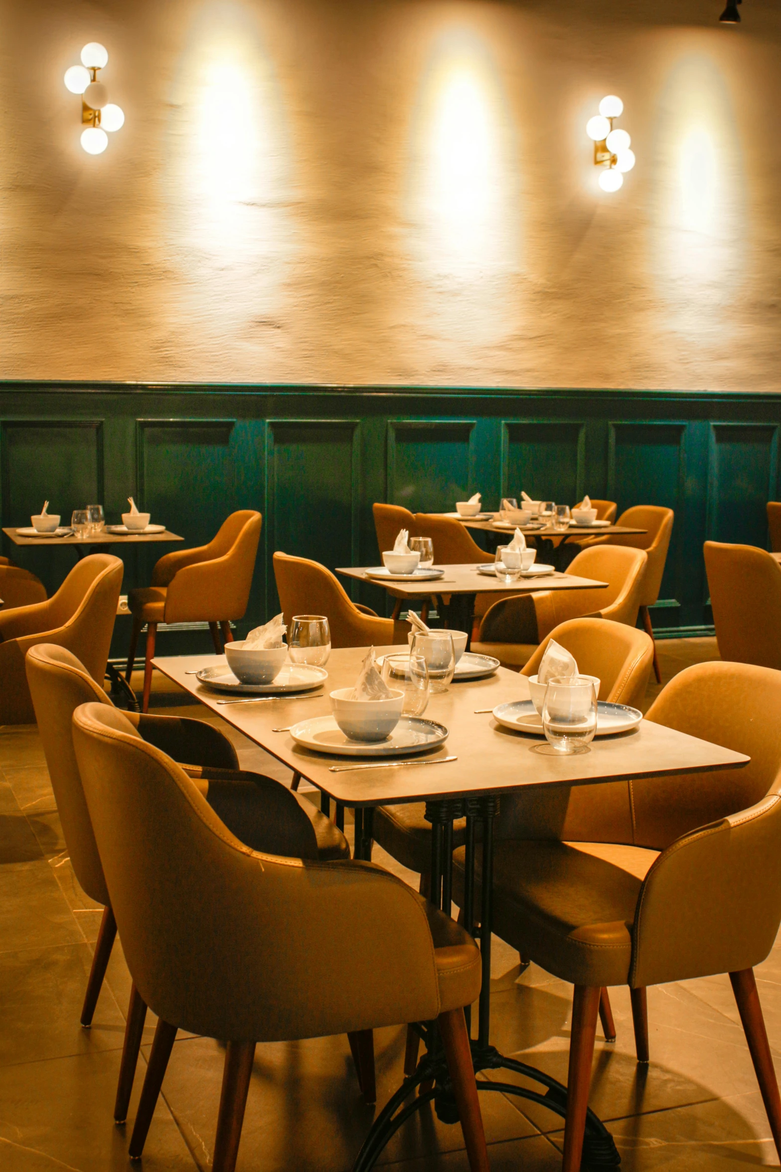 a restaurant has brown chairs and light up lamps