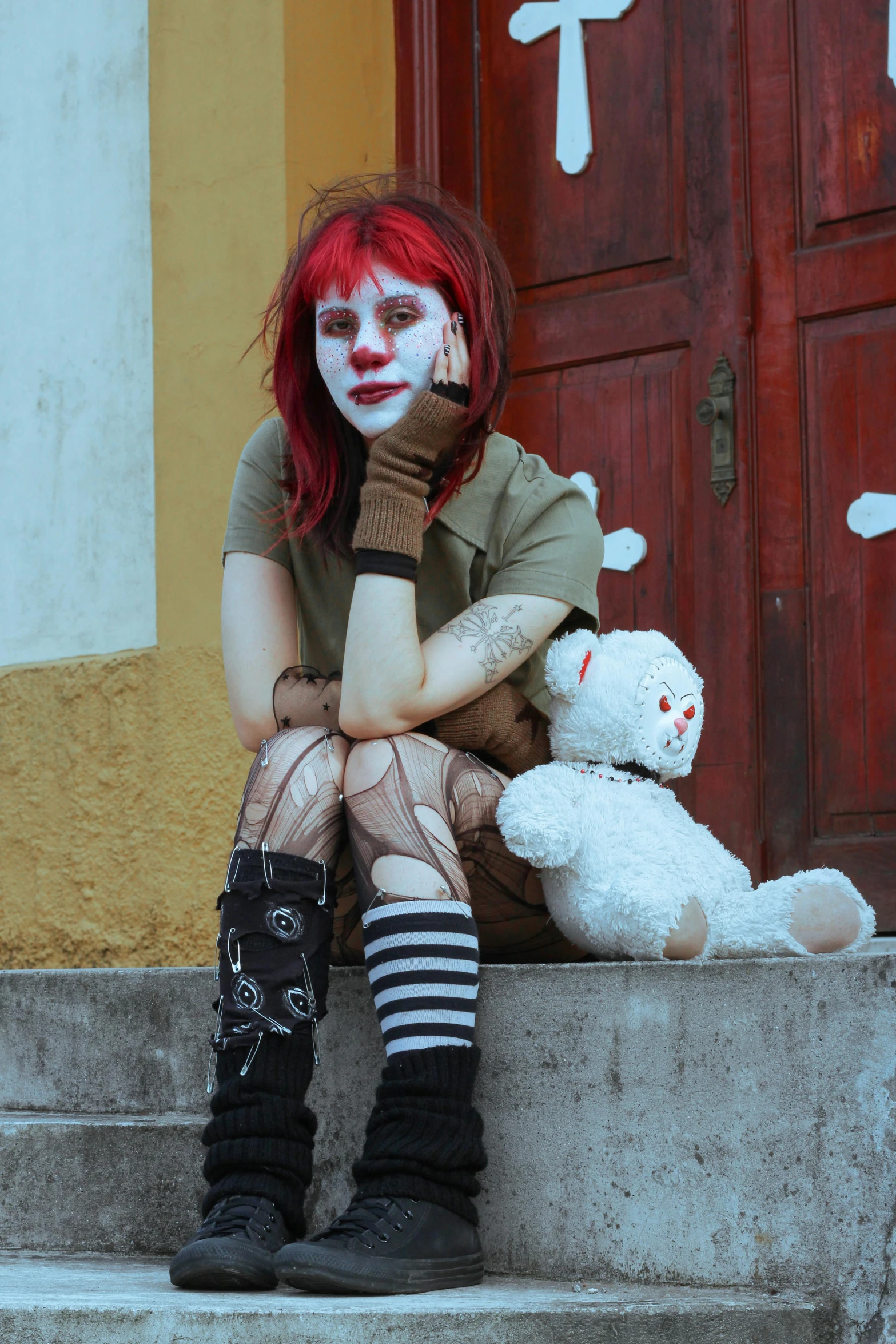 a person that is sitting down with a stuffed animal