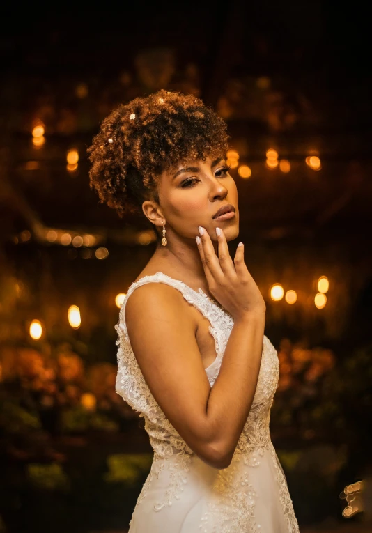 a woman in a wedding dress with her finger on her face