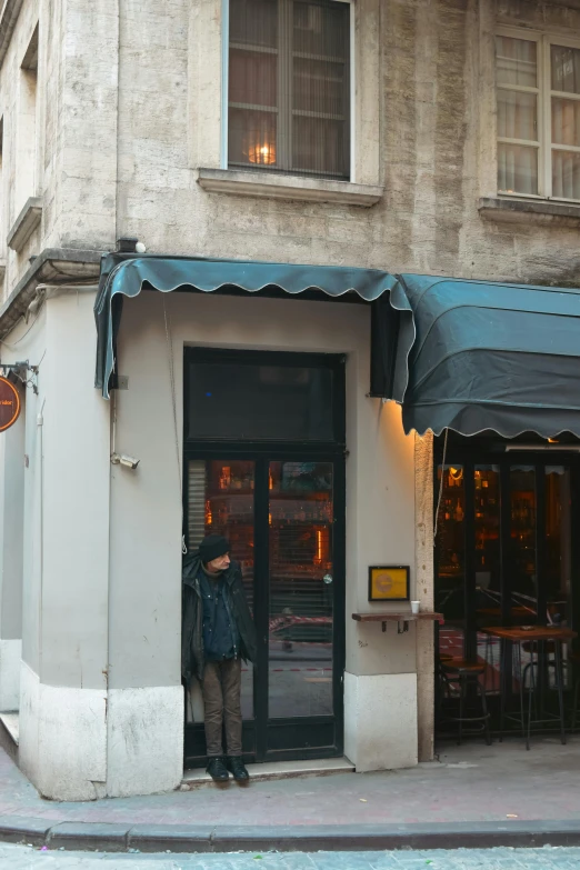 a man is standing in the door of a building