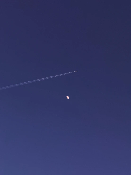 a plane is flying in the blue sky