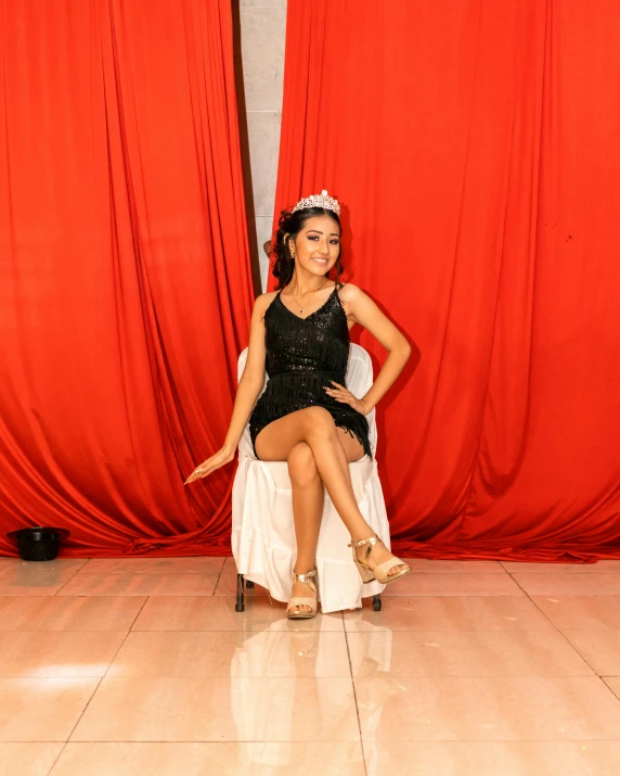 a woman sitting in a chair on a dance floor