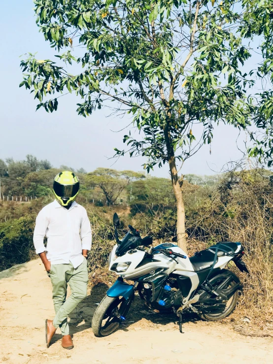 a man is walking next to his motorcycle