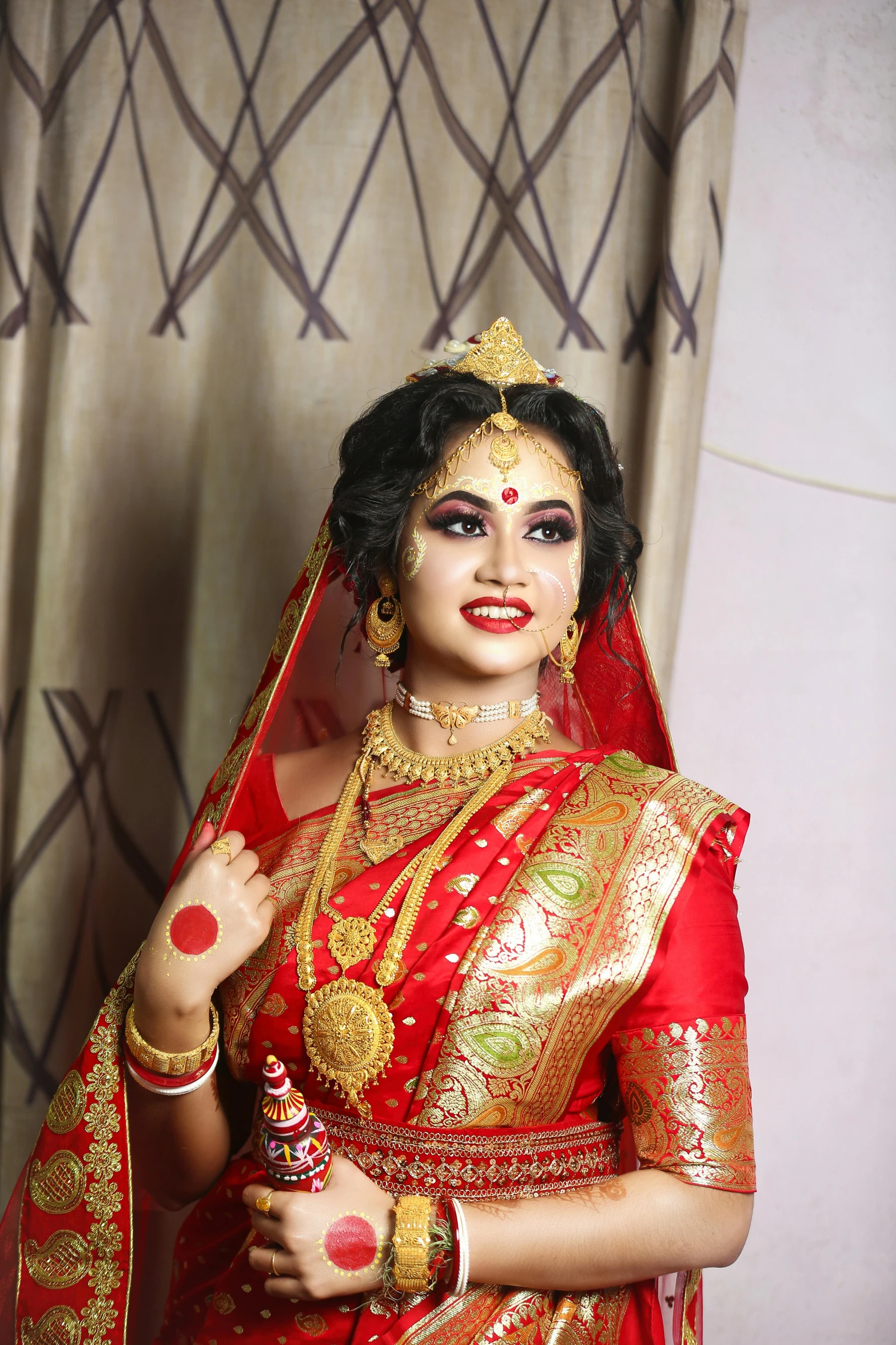 a woman in a red bridal gown and jewellery