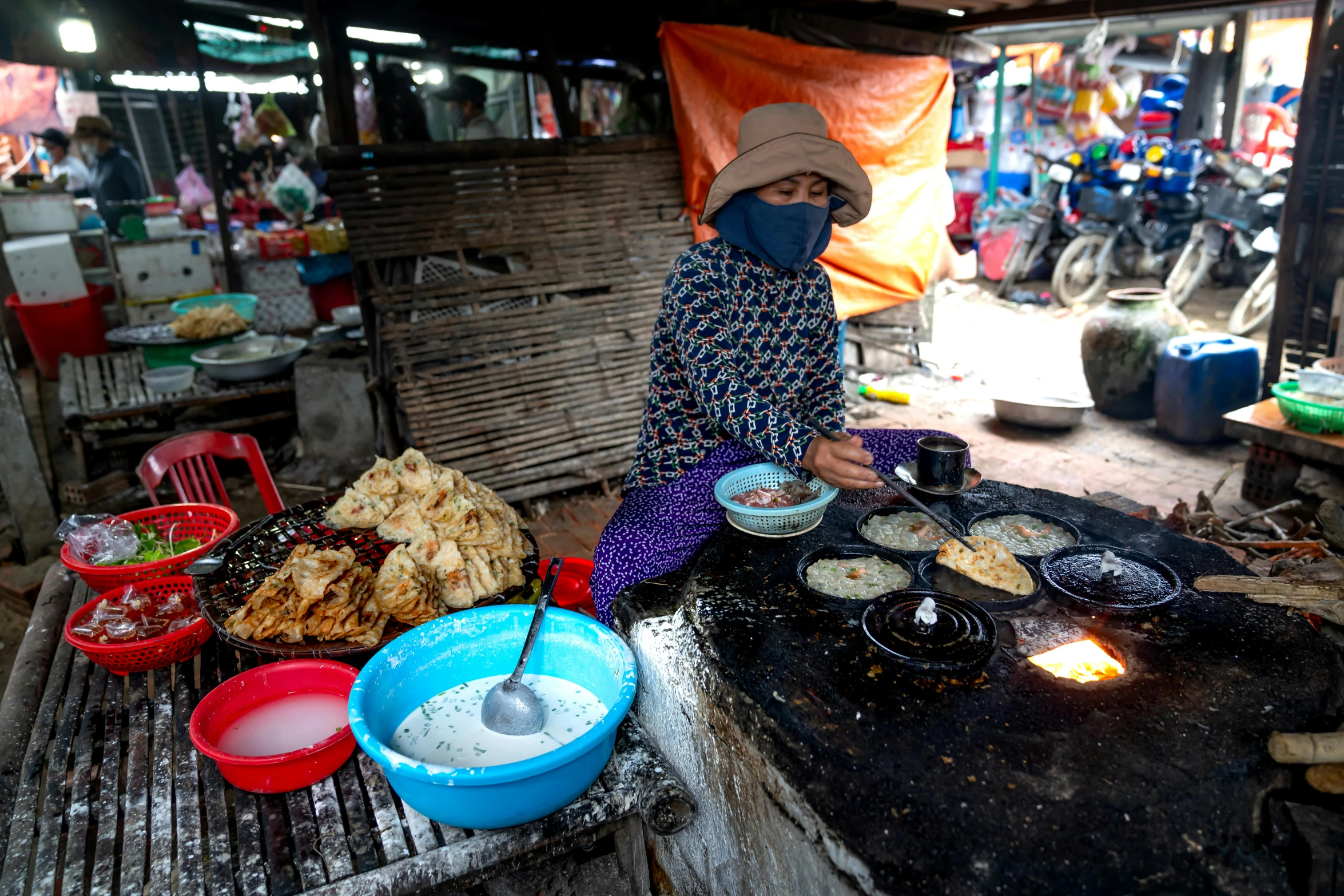 a person is cooking on an outdoor grill