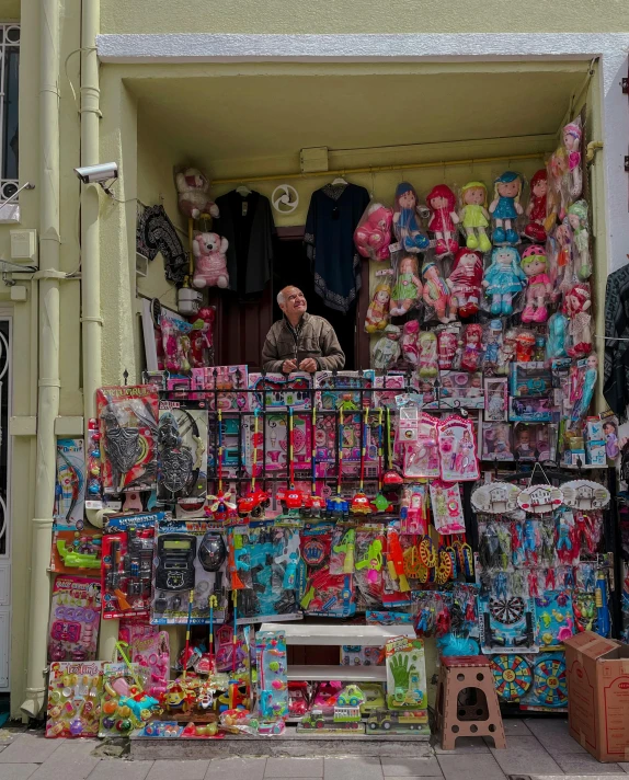 a man in the back of a vehicle with many items for sale