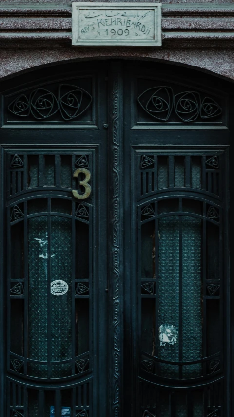 a couple of black doors on a red building