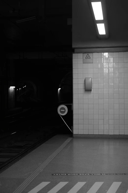 a subway station has a subway train next to it