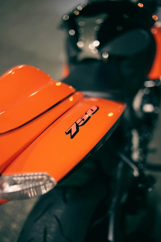 the view from behind the headlight of an orange motorcycle