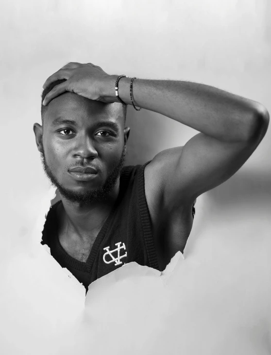 a man looks up while standing in front of a white background