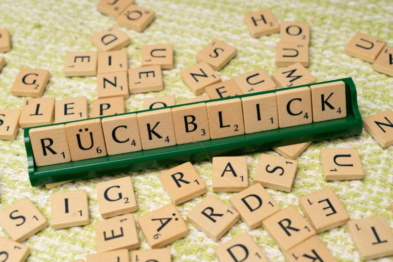 scrabble letters spelling the word rough bldck in blocks