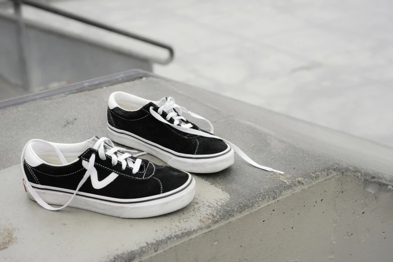 a pair of black and white shoes on concrete steps